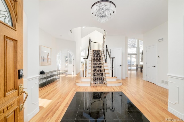 foyer with hardwood / wood-style flooring and a notable chandelier