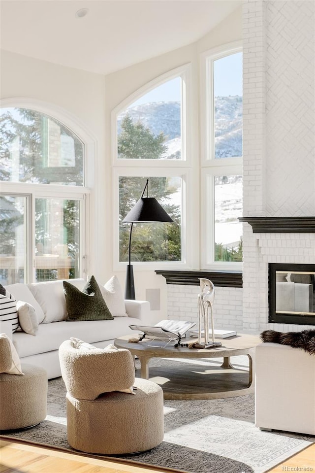 sunroom / solarium featuring a brick fireplace