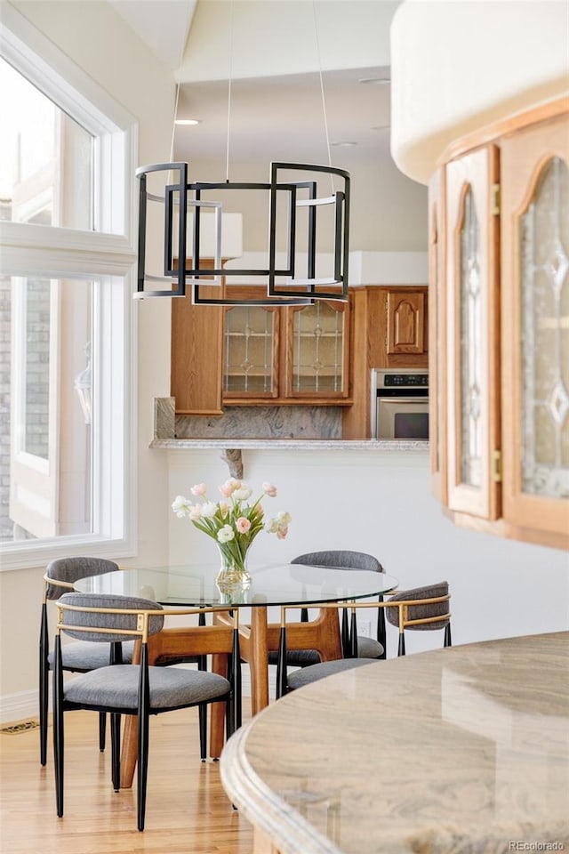 dining space with light hardwood / wood-style floors