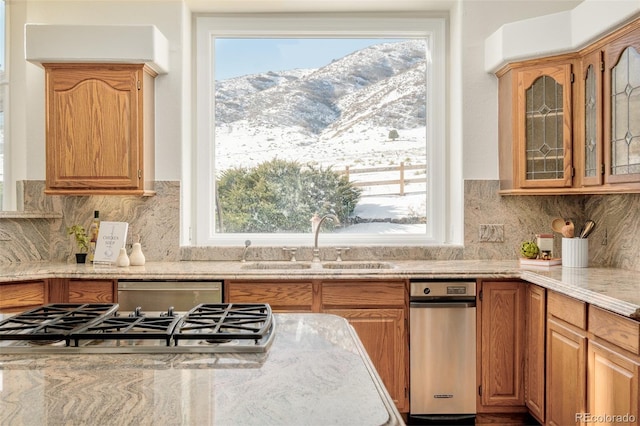 kitchen featuring a healthy amount of sunlight, a mountain view, sink, and appliances with stainless steel finishes