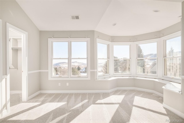 unfurnished sunroom featuring a mountain view