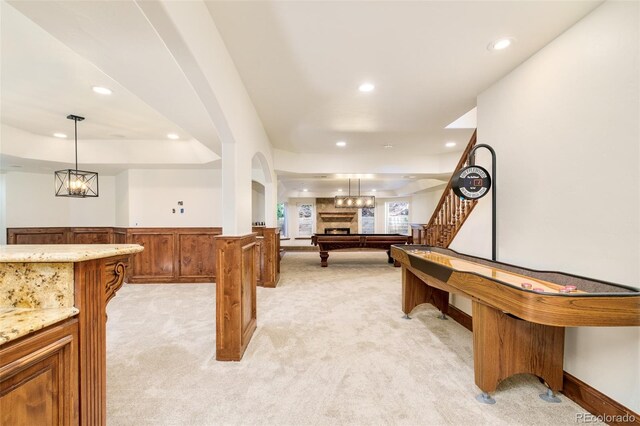 rec room featuring light colored carpet, pool table, and a tray ceiling