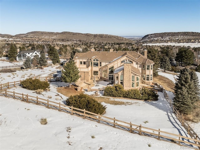 snowy aerial view featuring a mountain view