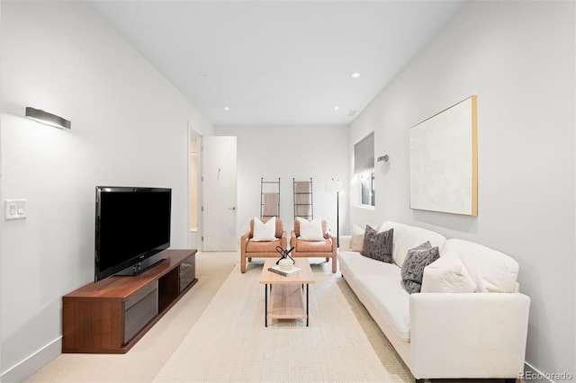 living area with recessed lighting and light colored carpet