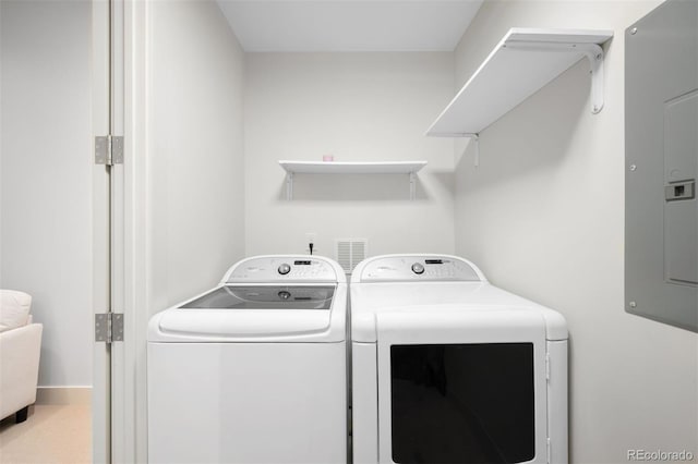 clothes washing area with laundry area, electric panel, and washing machine and clothes dryer