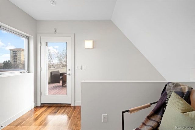 doorway to outside with light wood-style flooring and baseboards