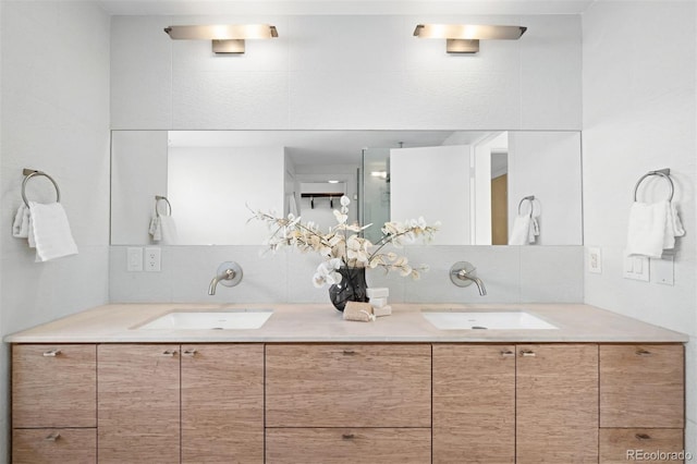 bathroom with a sink, decorative backsplash, and double vanity