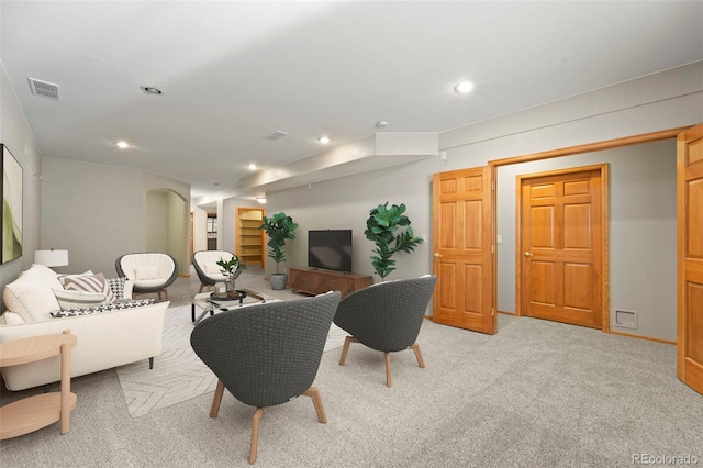 living room featuring visible vents, recessed lighting, and light carpet