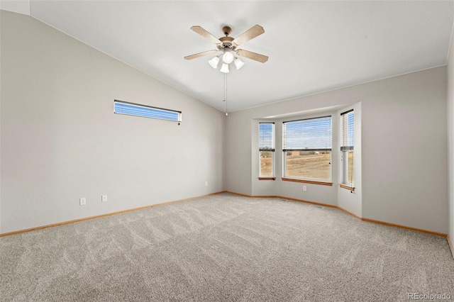 carpeted empty room with baseboards, lofted ceiling, and a ceiling fan