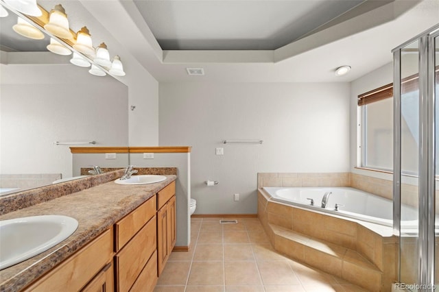 full bathroom featuring a tray ceiling, tile patterned floors, visible vents, and a sink