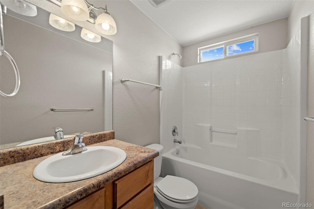 bathroom featuring toilet, vanity, shower / bathtub combination, and a textured wall