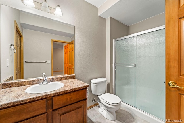 full bath with a shower stall, toilet, vanity, a textured wall, and tile patterned flooring