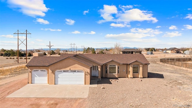 single story home featuring fence, driveway, stucco siding, and an attached garage