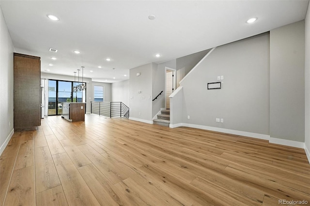 2074 S Holly St Unit 2, Denver, CO 80222 - unfurnished living room with light wood-style flooring and recessed lighting