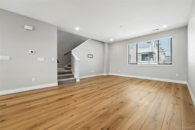 2074 S Holly St Unit 2, Denver, CO 80222 - unfurnished living room featuring stairs, light wood-type flooring, and recessed lighting