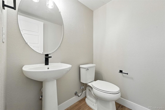 2074 S Holly St Unit 2, Denver, CO 80222 - half bathroom with baseboards and wood finished floors