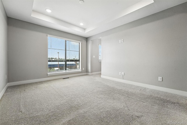 2074 S Holly St Unit 2, Denver, CO 80222 - unfurnished room featuring a tray ceiling, carpet, and recessed lighting