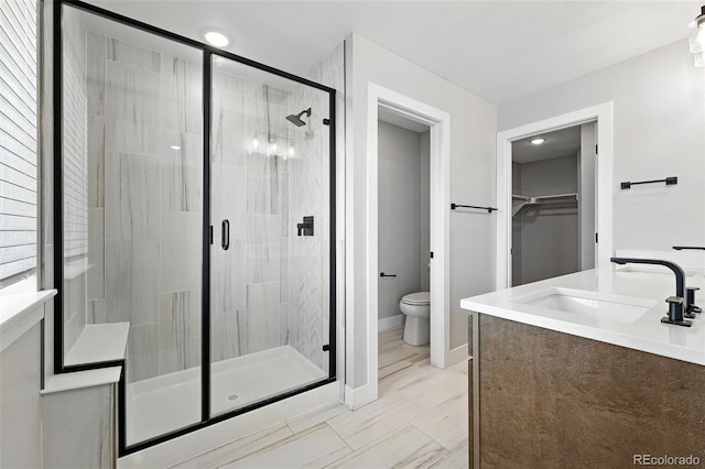 2074 S Holly St Unit 2, Denver, CO 80222 - full bathroom with a shower stall, vanity, and a walk in closet