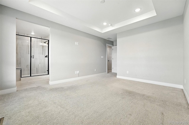 2074 S Holly St Unit 2, Denver, CO 80222 - spare room featuring carpet floors, a tray ceiling, and recessed lighting