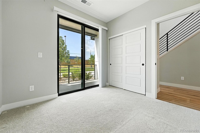 2074 S Holly St Unit 2, Denver, CO 80222 - unfurnished bedroom with access to exterior, carpet, and a closet