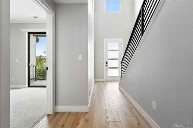 2074 S Holly St Unit 2, Denver, CO 80222 - hall featuring light wood finished floors, plenty of natural light, and stairs