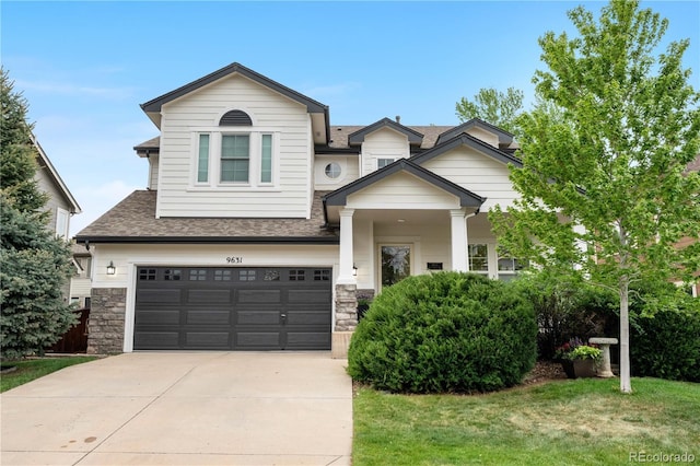 9631 S Dover Way, Littleton, CO 80127 - view of front of property featuring concrete driveway, stone siding, a garage, roof with shingles, and a front yard