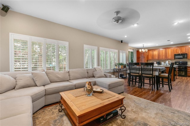 9631 S Dover Way, Littleton, CO 80127 - living room with wood finished floors, ceiling fan, a chandelier, and recessed lighting