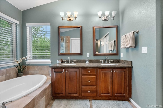9631 S Dover Way, Littleton, CO 80127 - full bathroom featuring a garden tub, a chandelier, and double vanity