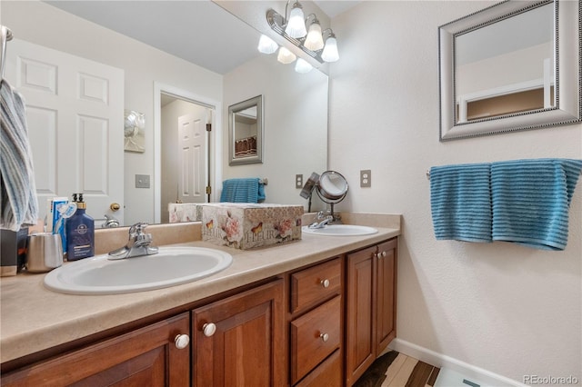 9631 S Dover Way, Littleton, CO 80127 - full bathroom featuring double vanity and wood finished floors