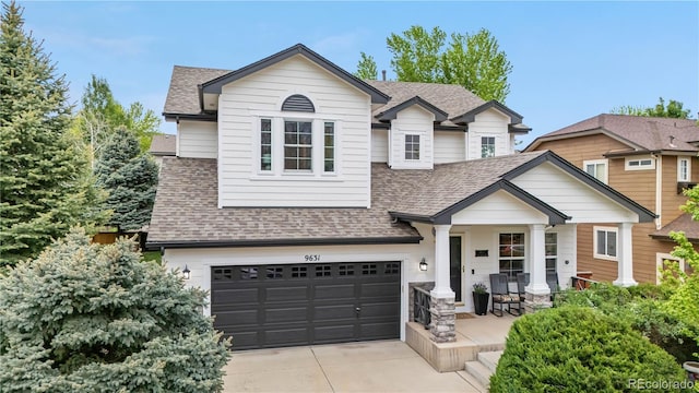 9631 S Dover Way, Littleton, CO 80127 - view of front facade with roof with shingles, a garage, concrete driveway, and a porch