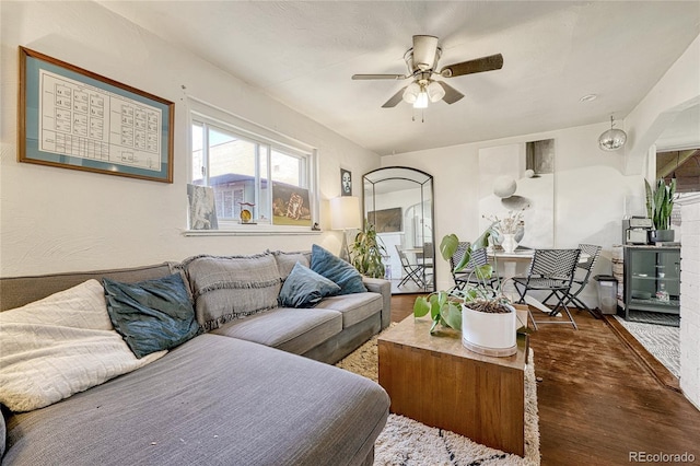 living room featuring dark hardwood / wood-style floors and ceiling fan