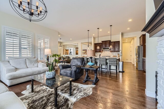 14969 Elsinore Ave, Parker, CO 80134 - living area with dark wood-type flooring, a chandelier, and recessed lighting