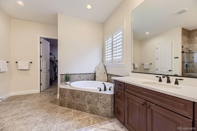 14969 Elsinore Ave, Parker, CO 80134 - full bath with vanity, a bath, a stall shower, recessed lighting, and a walk in closet