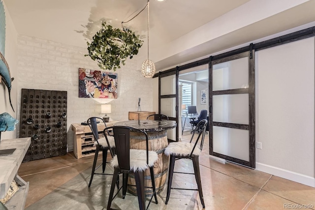 14969 Elsinore Ave, Parker, CO 80134 - dining area featuring a barn door, concrete flooring, and baseboards