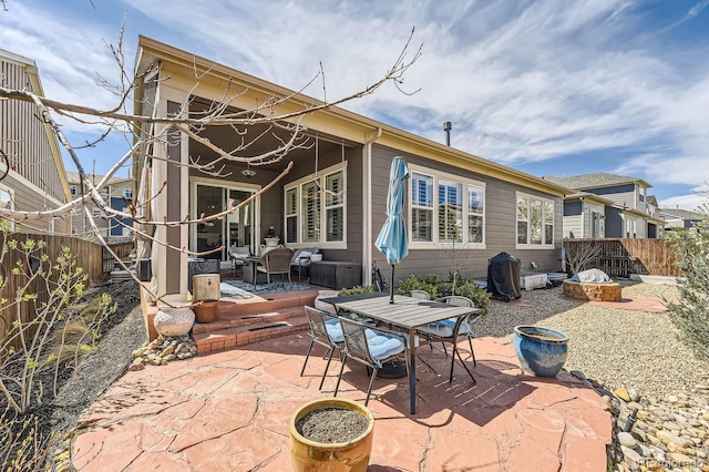 14969 Elsinore Ave, Parker, CO 80134 - rear view of house with a patio, a fenced backyard, an outdoor living space, and outdoor dining space