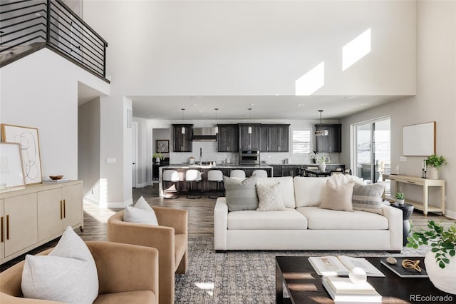 living room with dark hardwood / wood-style flooring and a high ceiling