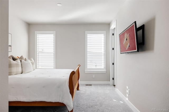 bedroom featuring light carpet