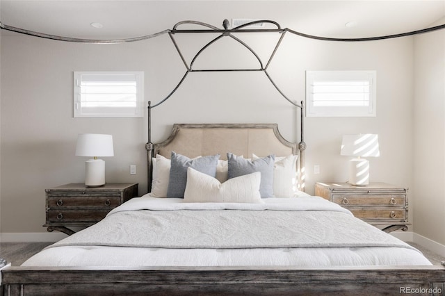 carpeted bedroom featuring multiple windows