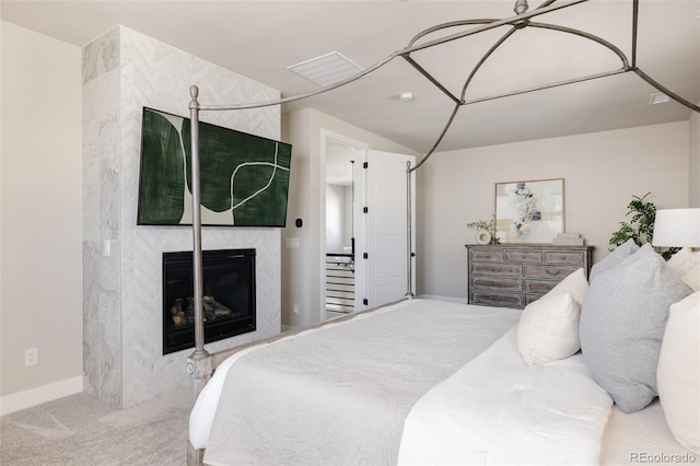 carpeted bedroom featuring a fireplace