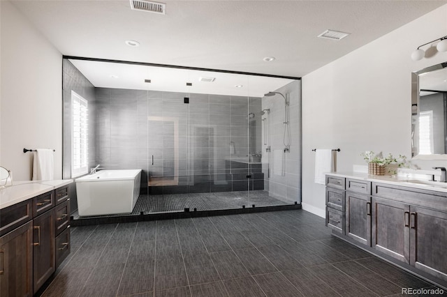 bathroom with vanity, a healthy amount of sunlight, and shower with separate bathtub