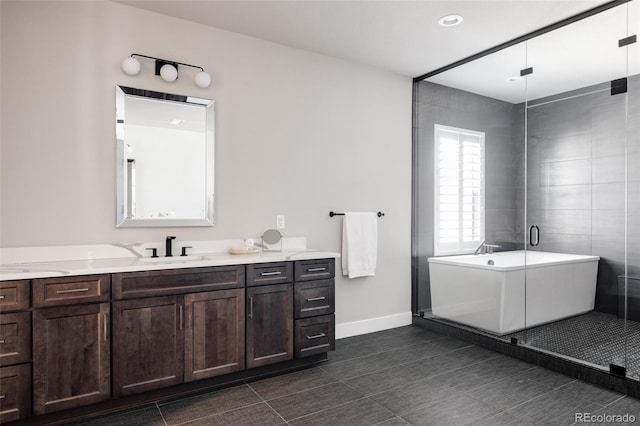 bathroom featuring tile patterned floors, a bathing tub, and vanity