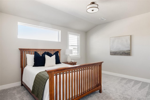 bedroom with light carpet and vaulted ceiling