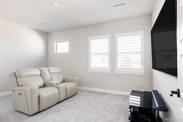 sitting room featuring light carpet