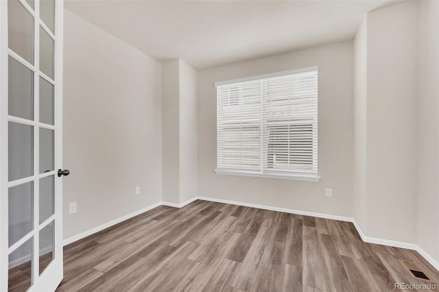 3325 Umber Cir, Castle Rock, CO 80109 - spare room featuring wood finished floors, baseboards, and french doors
