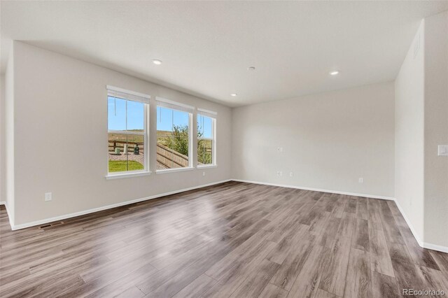 3325 Umber Cir, Castle Rock, CO 80109 - spare room with wood finished floors, baseboards, and recessed lighting