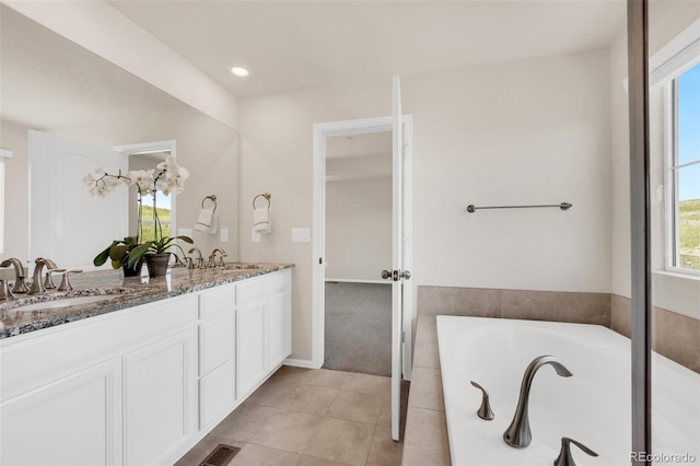 3325 Umber Cir, Castle Rock, CO 80109 - bathroom with double vanity, a garden tub, and tile patterned floors
