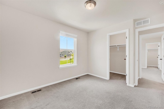 3325 Umber Cir, Castle Rock, CO 80109 - unfurnished bedroom featuring carpet flooring, baseboards, a walk in closet, and a closet