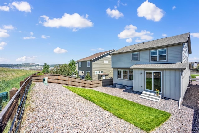 3325 Umber Cir, Castle Rock, CO 80109 - rear view of property with entry steps, board and batten siding, a fenced backyard, and a shingled roof