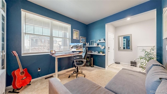 carpeted office space featuring visible vents and baseboards