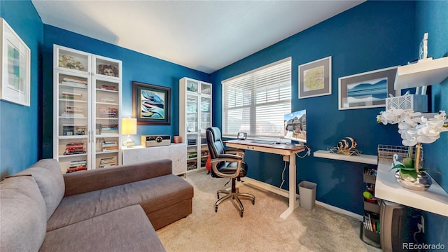 carpeted office featuring baseboards